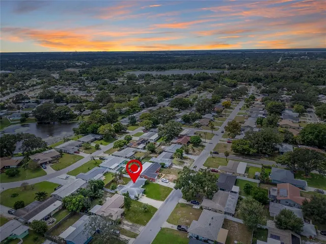 a view of a house with a backyard