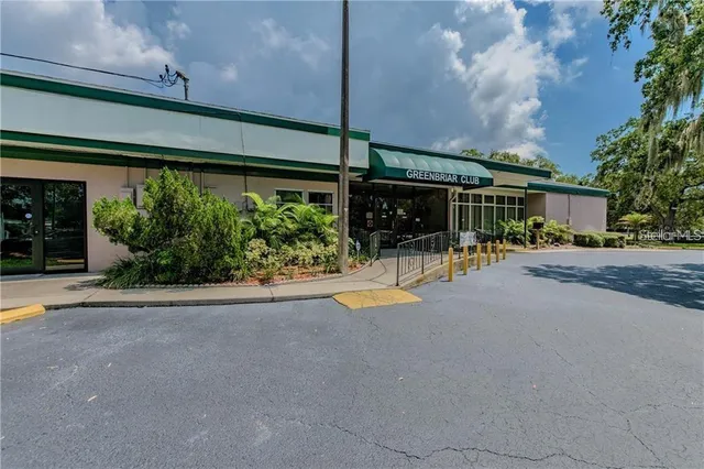 an aerial view of a house with a yard and trees