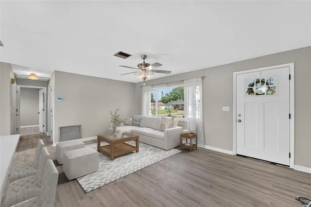 a living room with furniture and a large window