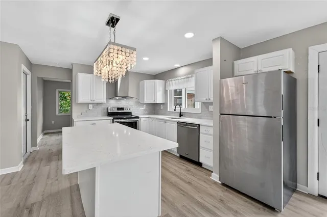 a kitchen with a sink stove and cabinets