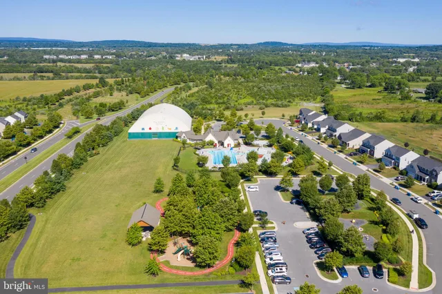 an aerial view of a house with a swimming pool yard and lake view