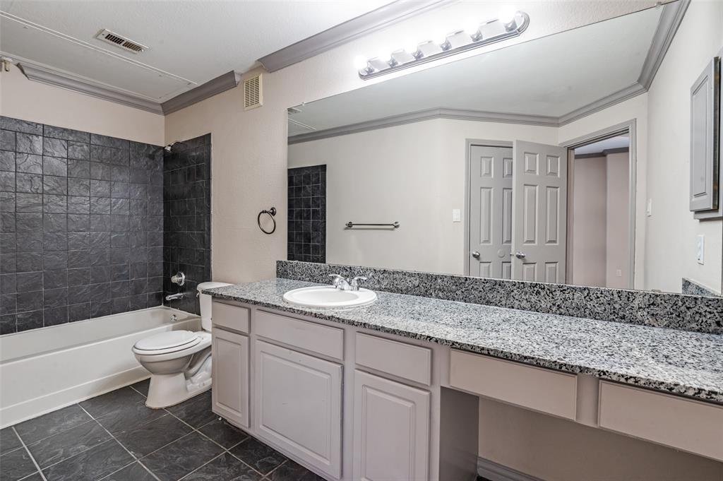 2524 Preston Road, Unit 1404 Plano, TX 75093 - Photo 10 of 15 a bathroom with a granite countertop sink mirror vanity and toilet