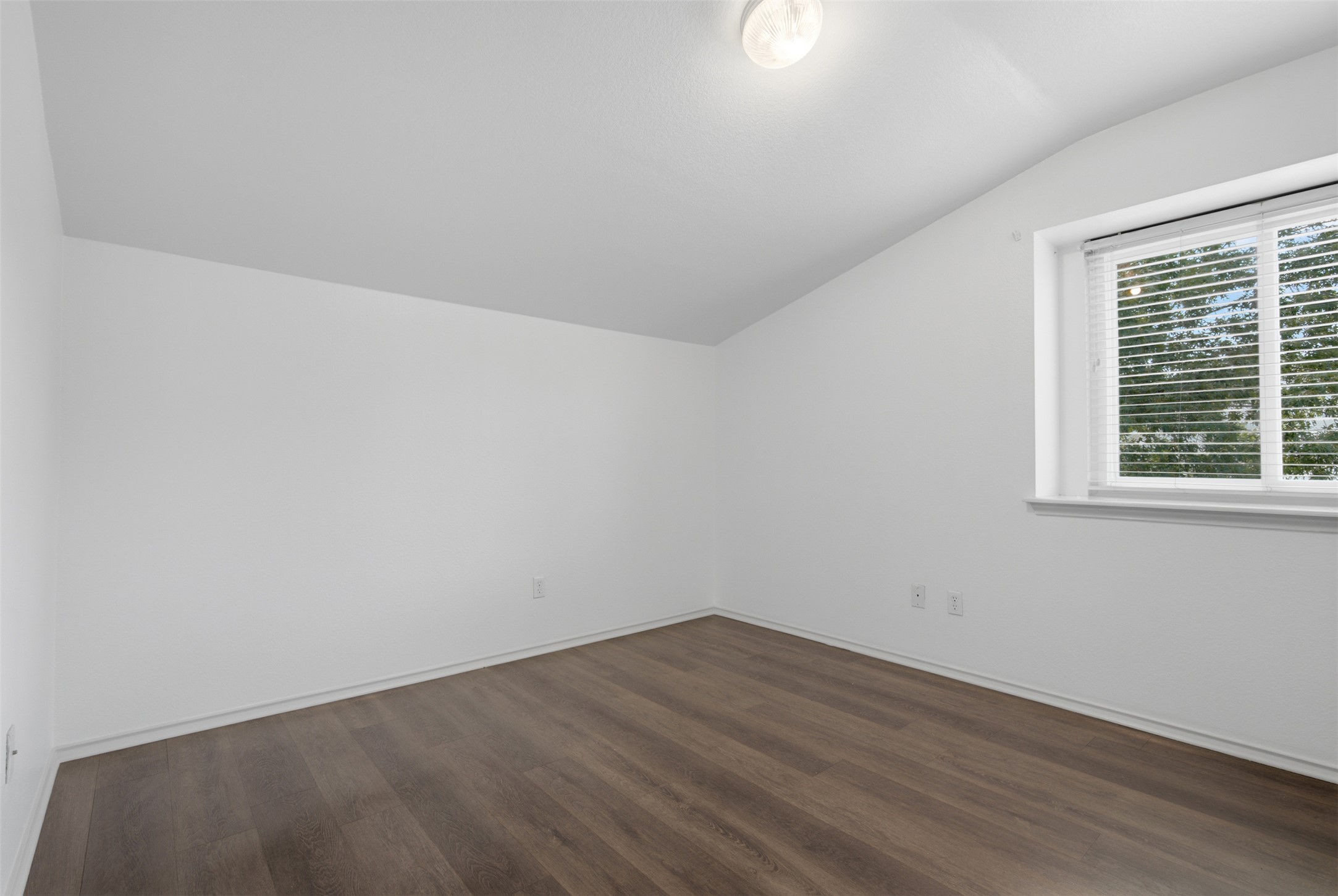 1416 Roxanne's Run Pflugerville, TX 78660 - Photo 24 of 35 A well-lit room showcases rich hardwood flooring and clean, minimalist design.