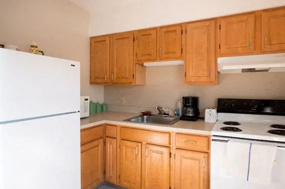 a kitchen with stainless steel appliances a refrigerator a sink a stove top oven