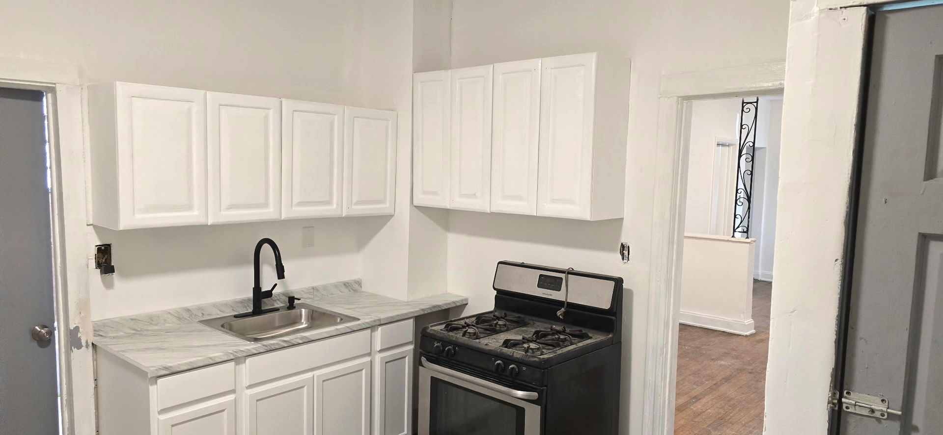 2046 West 69th Place Chicago, IL 60636 - Photo 11 of 12 a kitchen with stainless steel appliances granite countertop white cabinets and a stove
