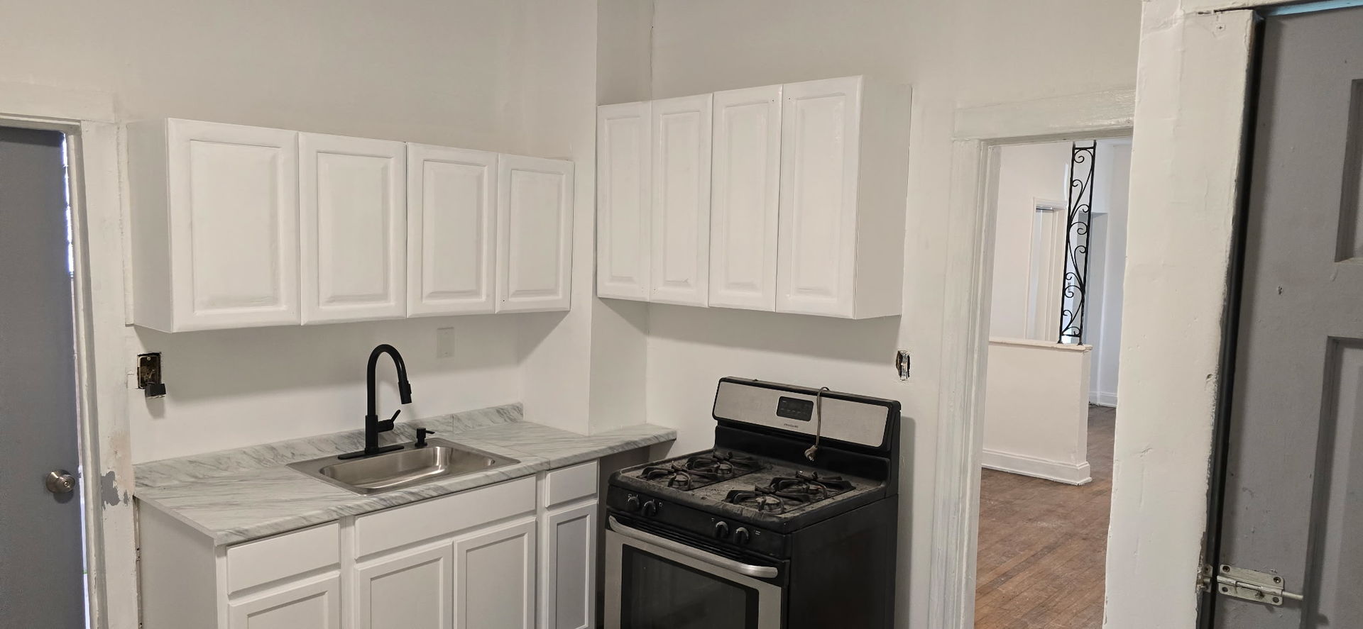 2046 West 69th Place Chicago, IL 60636 - Photo 12 of 12 a kitchen with stainless steel appliances granite countertop white cabinets and a stove