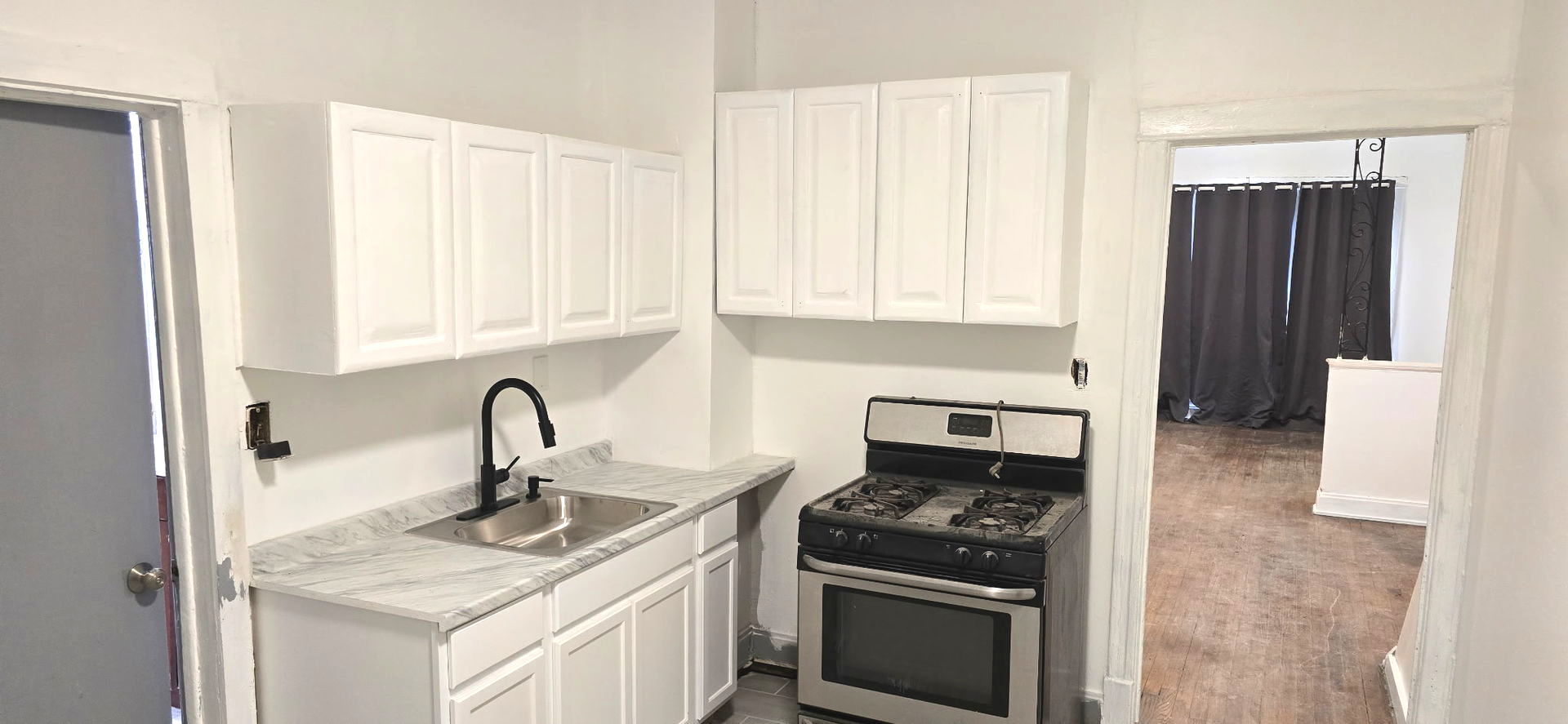 2046 West 69th Place Chicago, IL 60636 - Photo 9 of 12 a kitchen with a stove a sink and a refrigerator