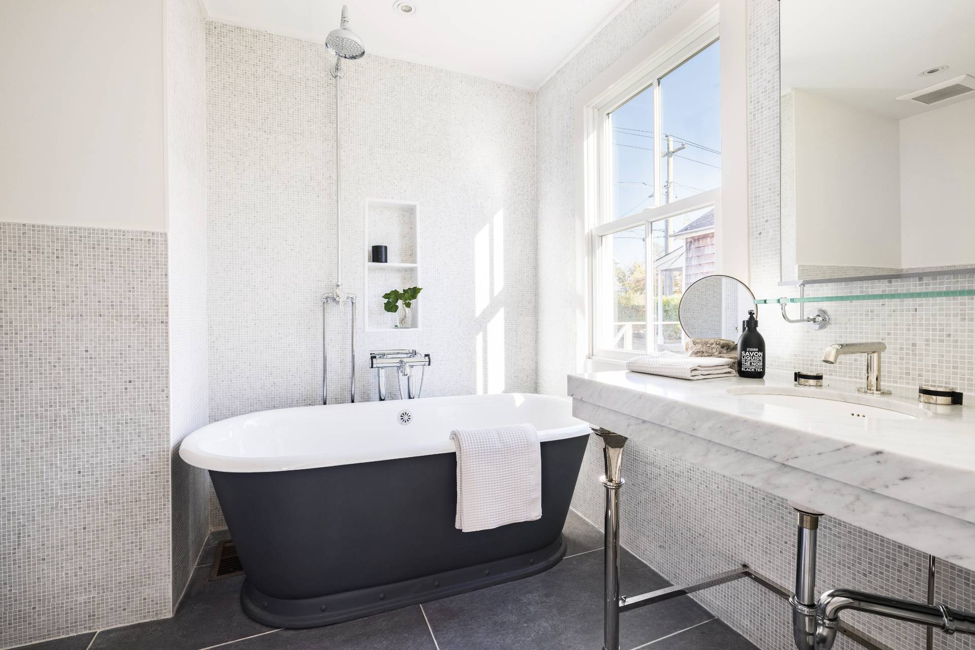 206 Division Street Sag Harbor, NY 11963 - Photo 11 of 24 a bathroom with a sink and a mirror