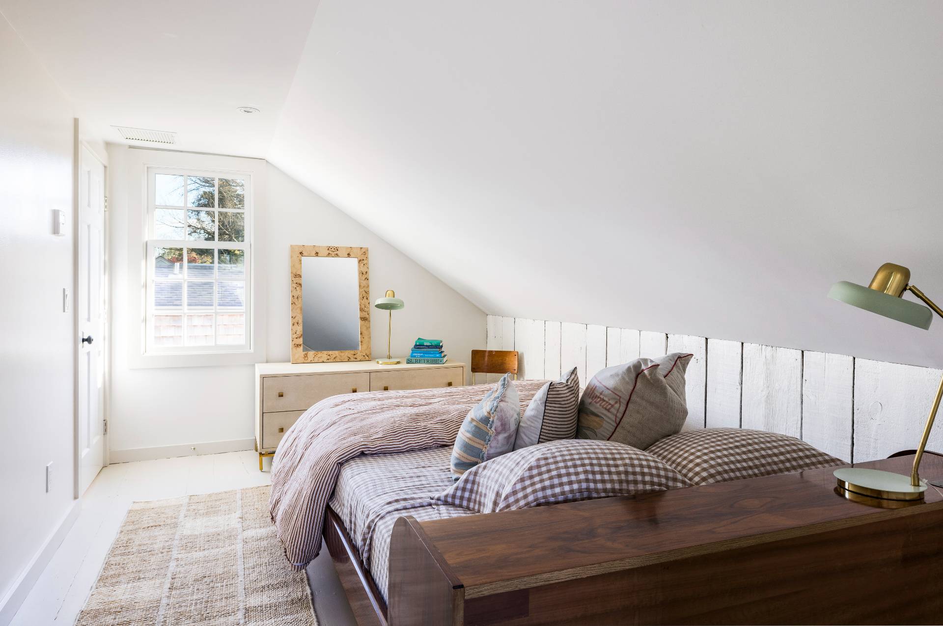 206 Division Street Sag Harbor, NY 11963 - Photo 12 of 24 a bedroom with a bed and wooden floor