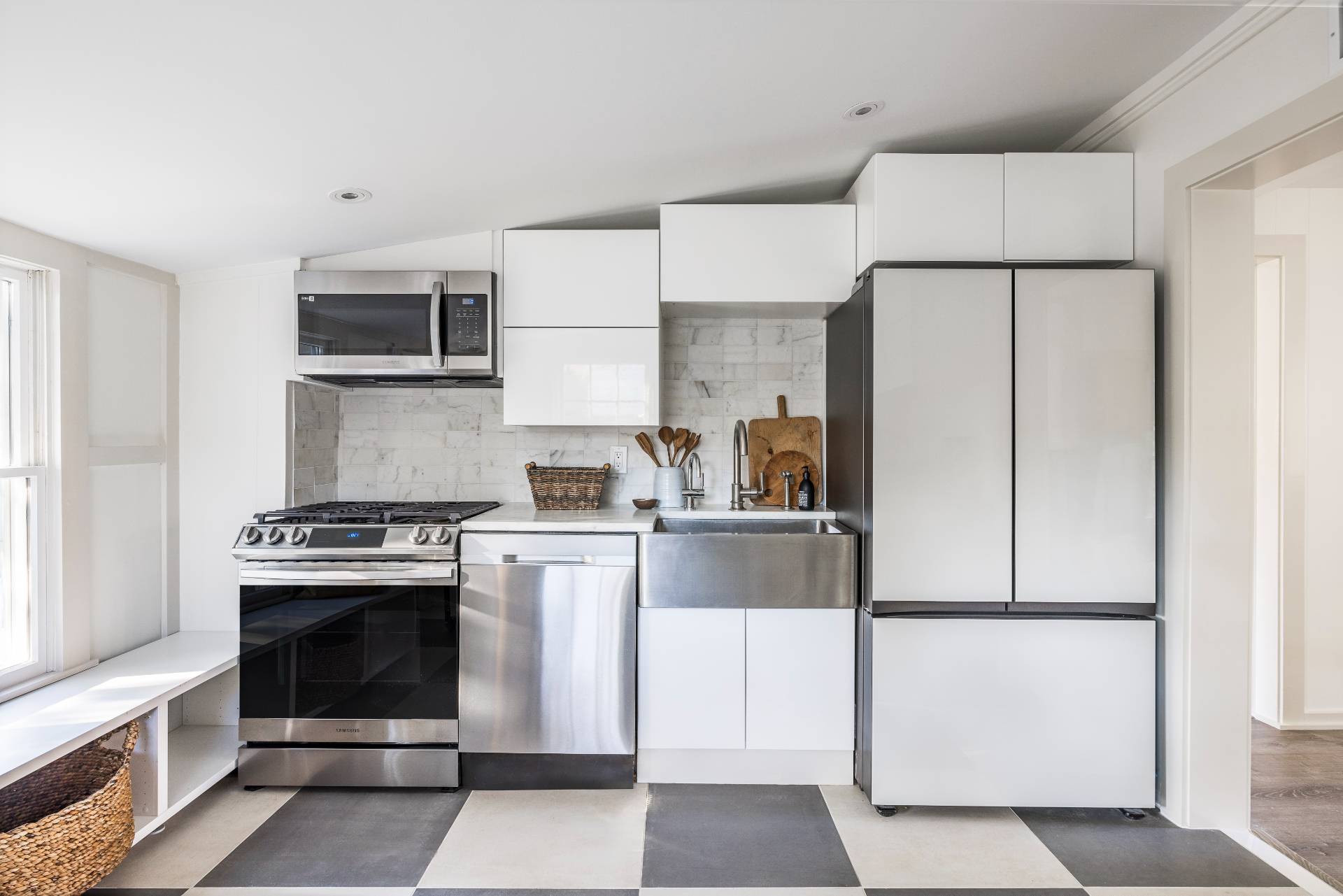 206 Division Street Sag Harbor, NY 11963 - Photo 18 of 24 a kitchen with cabinets stainless steel appliances and counter space
