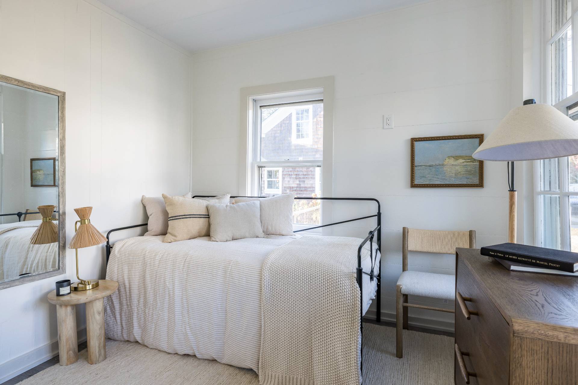 206 Division Street Sag Harbor, NY 11963 - Photo 20 of 24 a bedroom with a bed and a lamp