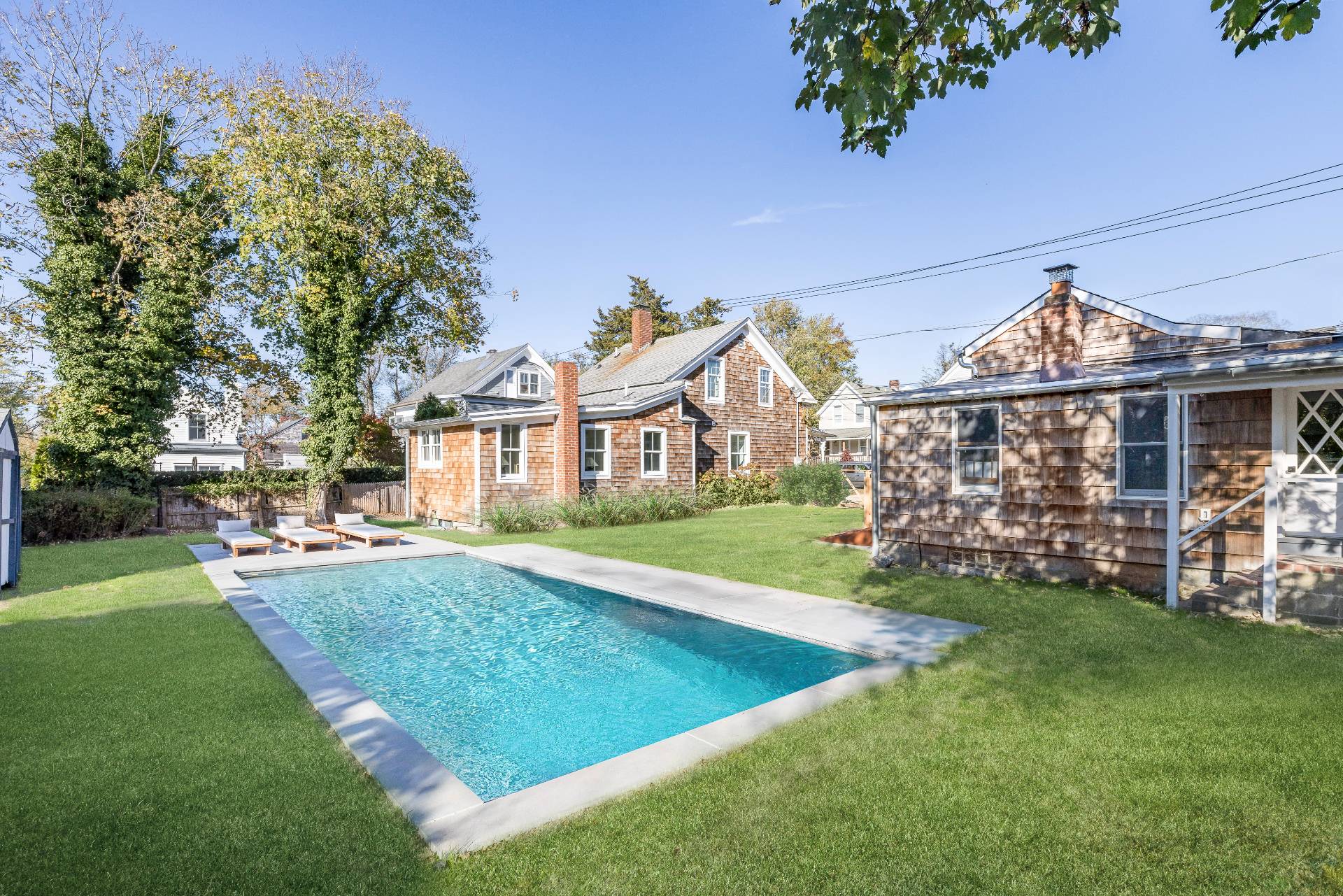 206 Division Street Sag Harbor, NY 11963 - Photo 22 of 24 a view of a house with a yard porch and sitting area