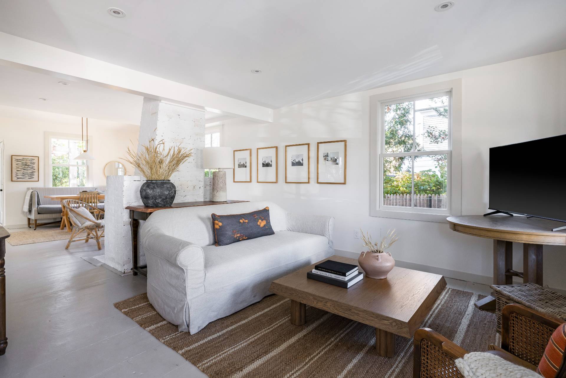 206 Division Street Sag Harbor, NY 11963 - Photo 3 of 24 a living room with furniture a flat screen tv and a window