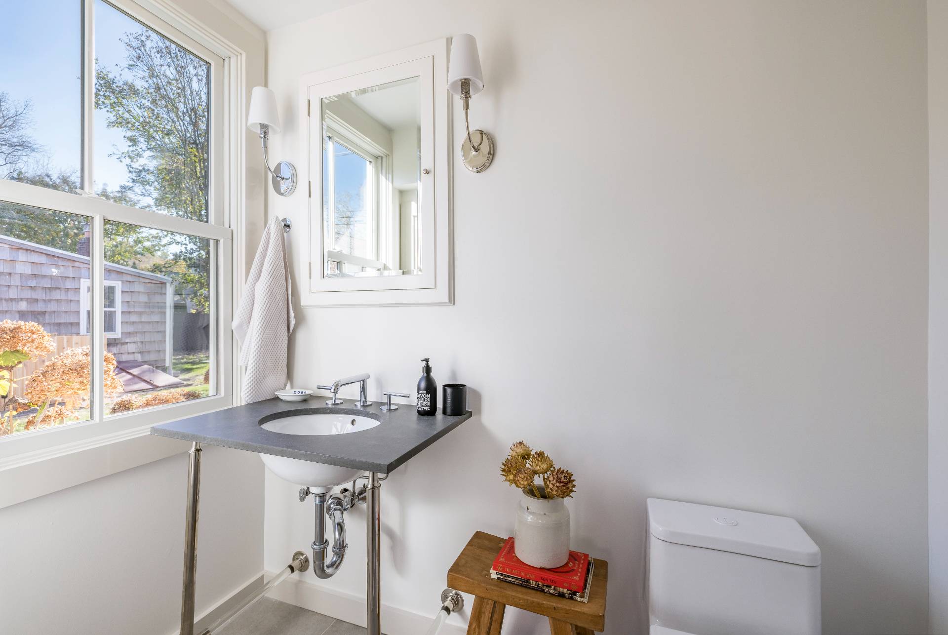 206 Division Street Sag Harbor, NY 11963 - Photo 8 of 24 a bathroom with a sink and a mirror