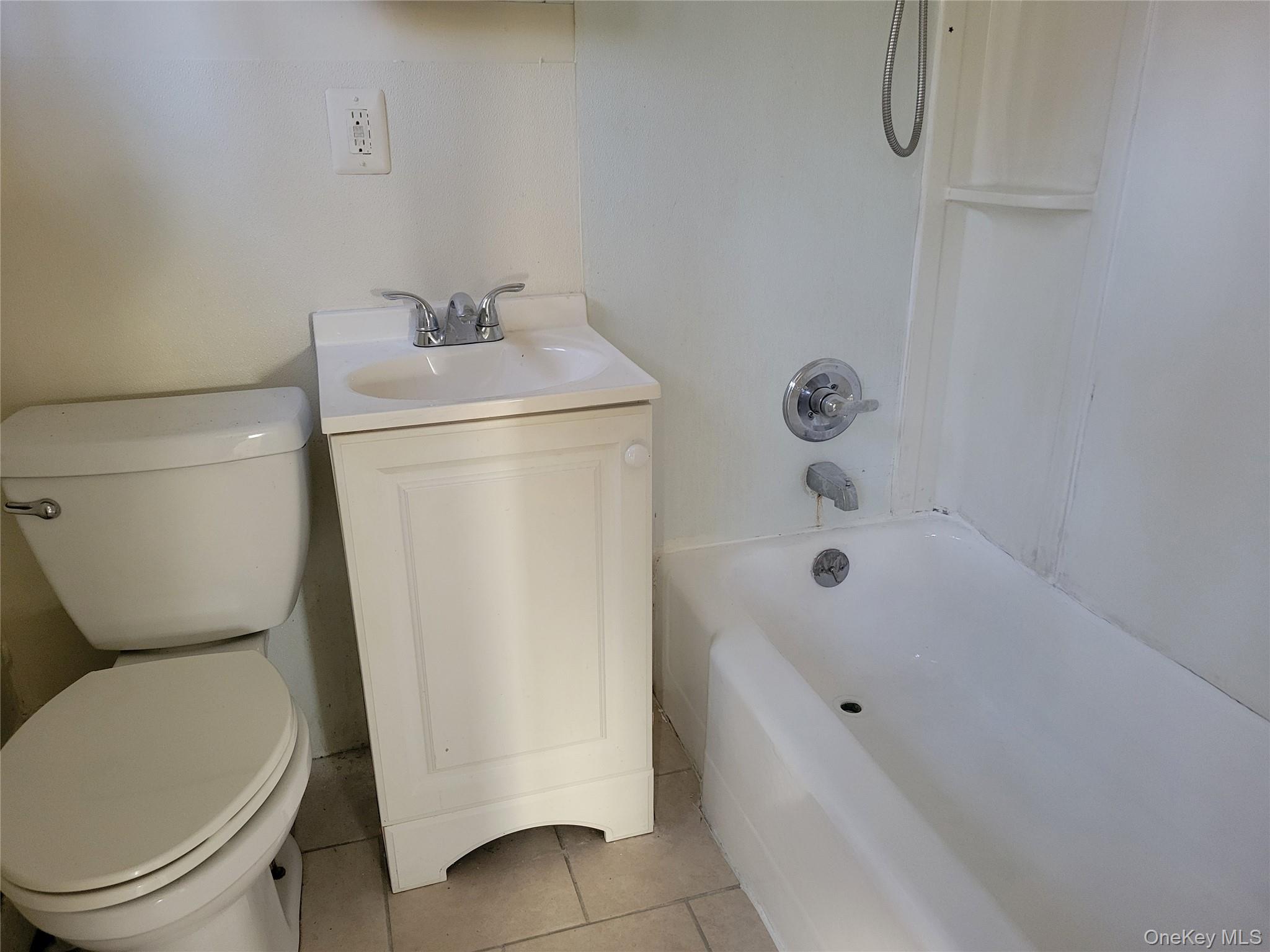 3479 Lexington Avenue, Unit L8 Mohegan Lake, NY 10547 - Photo 5 of 6 a bathroom with a sink a toilet and bathtub