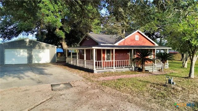 a view of a house with a yard and sitting area
