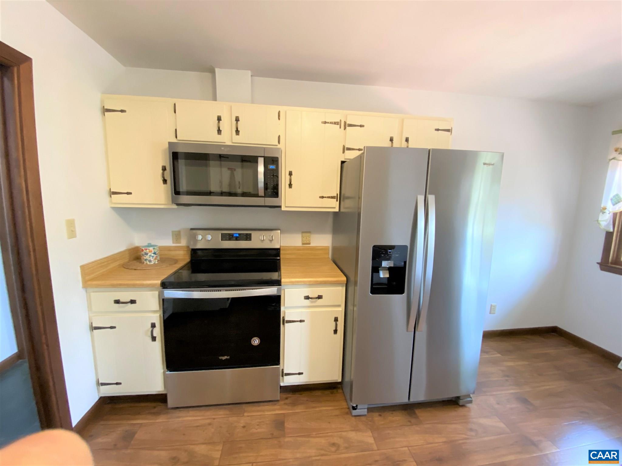 51 Oak Grove Road Palmyra, VA 22963 - Photo 3 of 52 a kitchen with stainless steel appliances a refrigerator a stove a microwave and cabinets