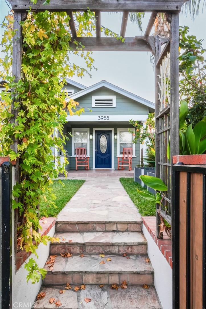a front view of a house with a garden and plants
