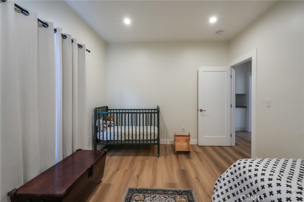 3958 Seneca Avenue Los Angeles, CA 90039 - Photo 35 of 48 a bedroom with a bed and wooden floor