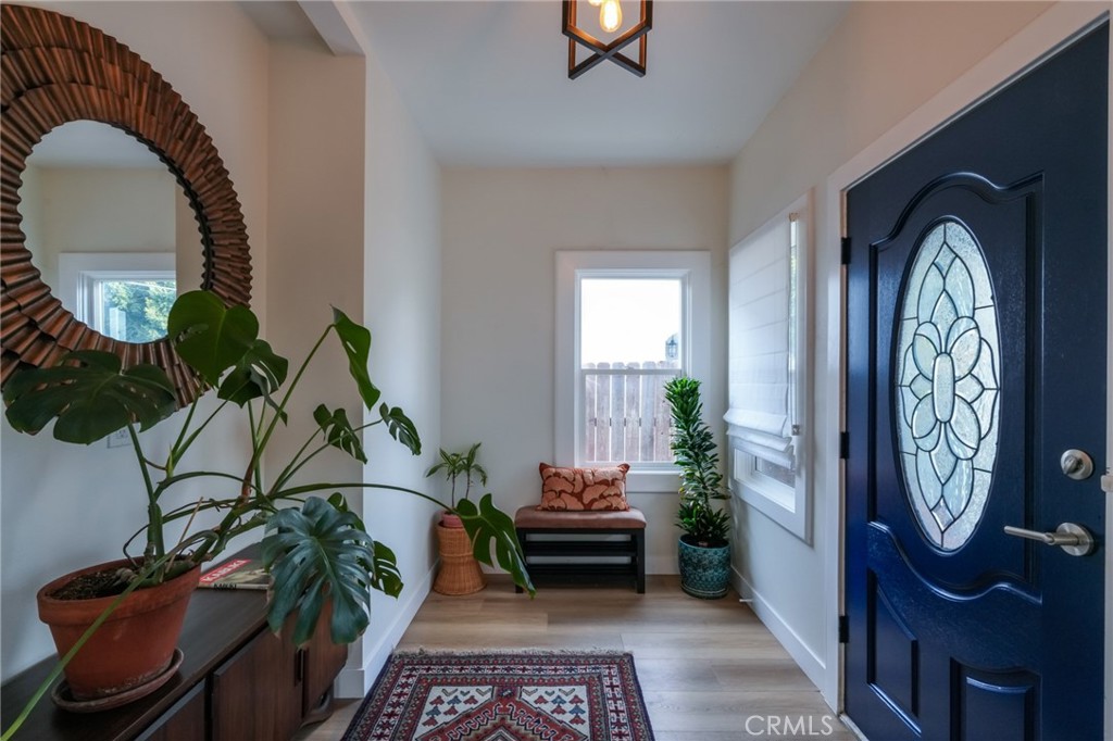 3958 Seneca Avenue Los Angeles, CA 90039 - Photo 5 of 48 a hallway with painting on the wall and a potted plant