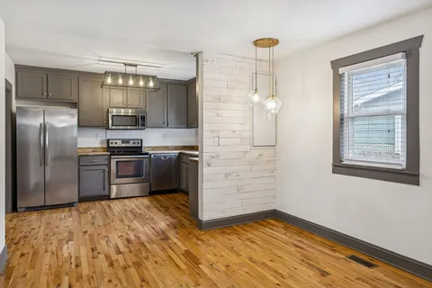 a kitchen with cabinets stainless steel appliances and a sink