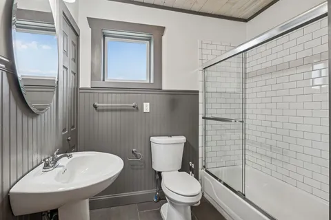 a balcony with wooden floor and outdoor seating