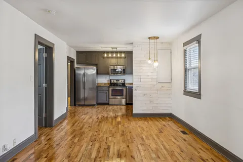 a kitchen with stainless steel appliances granite countertop a refrigerator and a sink
