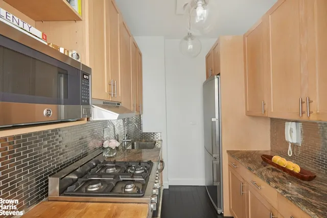 a bedroom with a bed and painting on the wall