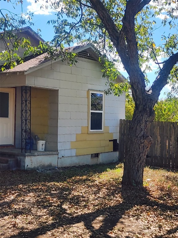 a view of a house with a large tree