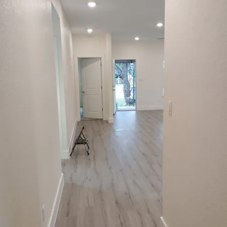 a view of a hallway and wooden floor