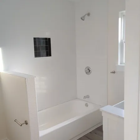 a bathroom with a bathtub and shower