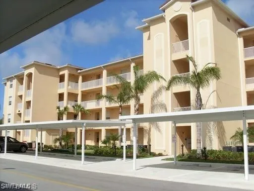 a front view of a building with a garden