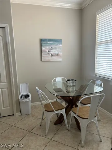 a view of a dining room with furniture and window