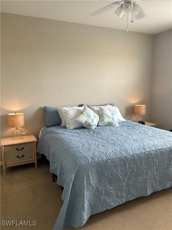 Undisclosed Address Estero, FL 33967 - Photo 14 of 18 a bedroom with a bed and a chandelier