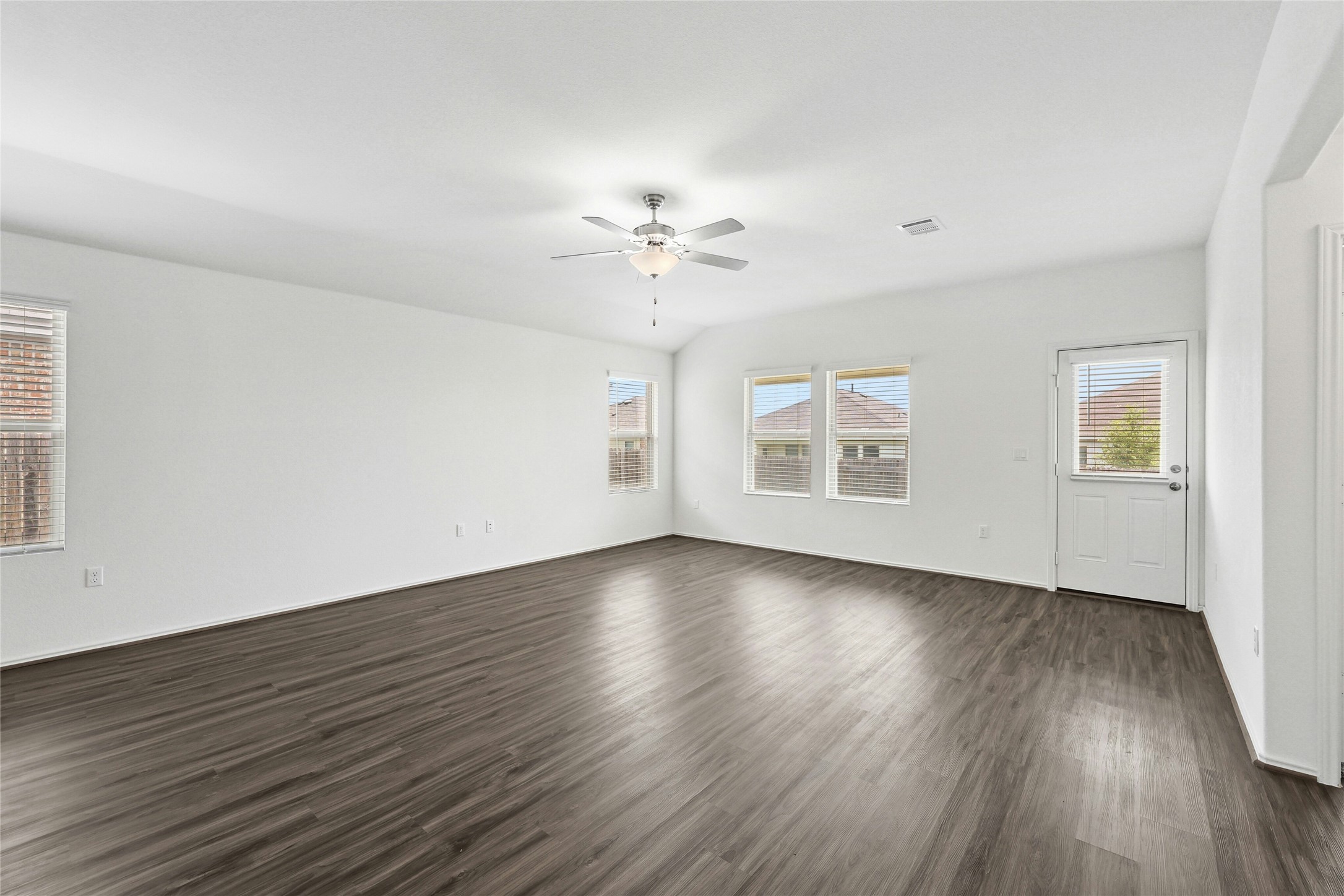 11813 Roscommon Trail Austin, TX 78754 - Photo 13 of 28 a view of an empty room with wooden floor and a window