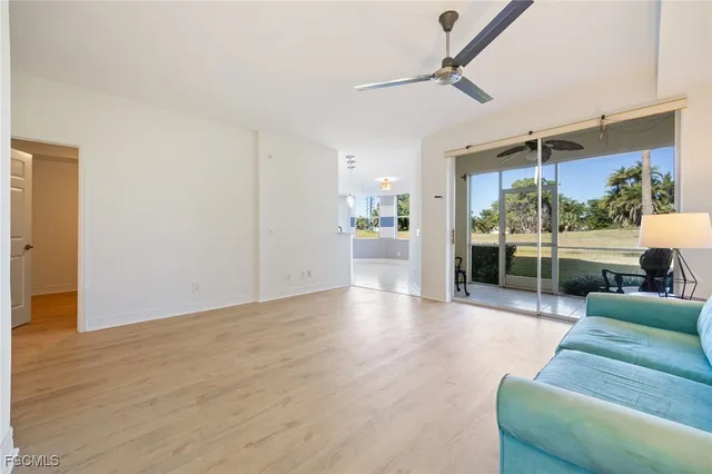 a living room with furniture and a floor to ceiling window
