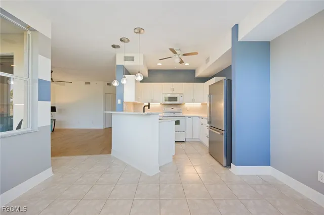 a kitchen with kitchen island cabinets and refrigerator