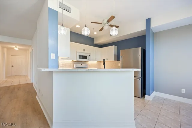 a kitchen with granite countertop cabinets and refrigerator