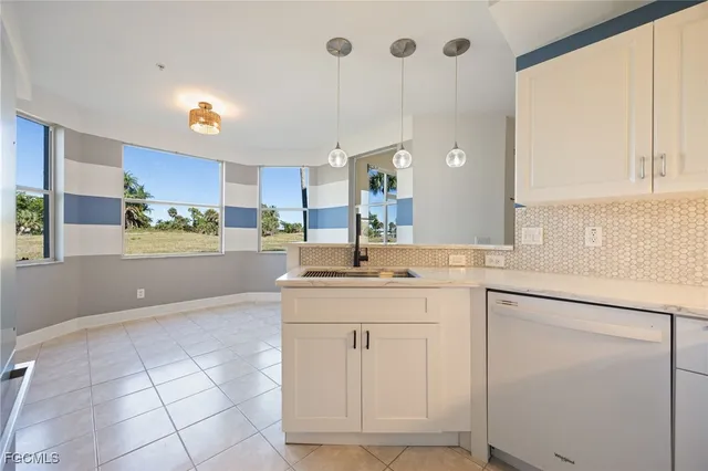 a kitchen with stainless steel appliances granite countertop a sink and cabinets