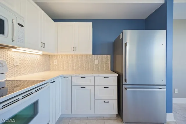 a view of cabinets and refrigerator