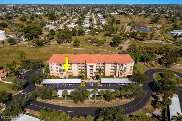 an aerial view of residential houses with outdoor space and swimming pool