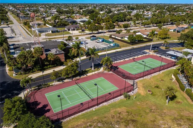 an aerial view of a pool a yard and mountain view in back