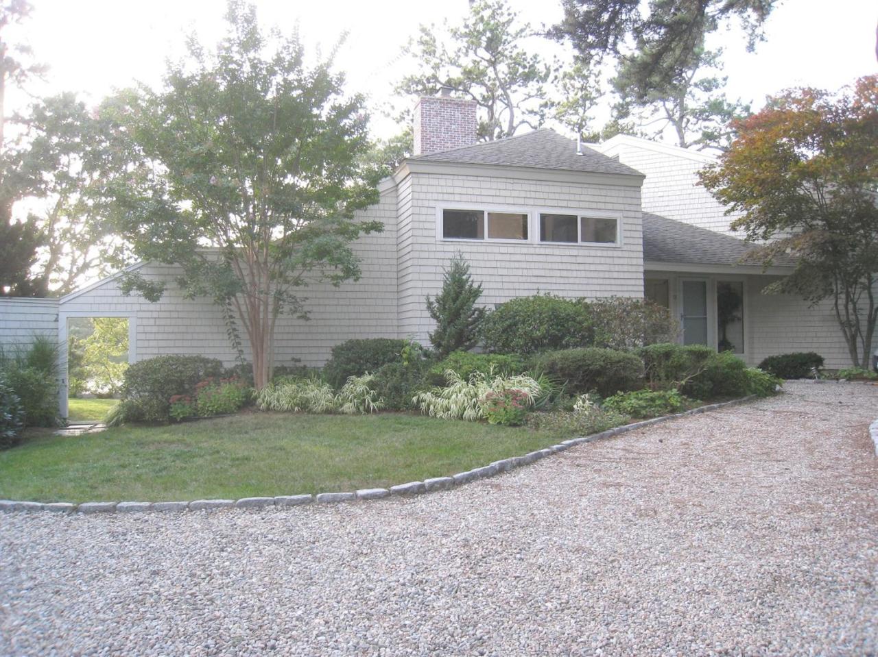 72 Clam Shell Point Lane Cotuit, MA 02635 - Photo 1 of 35 a view of a house with a backyard
