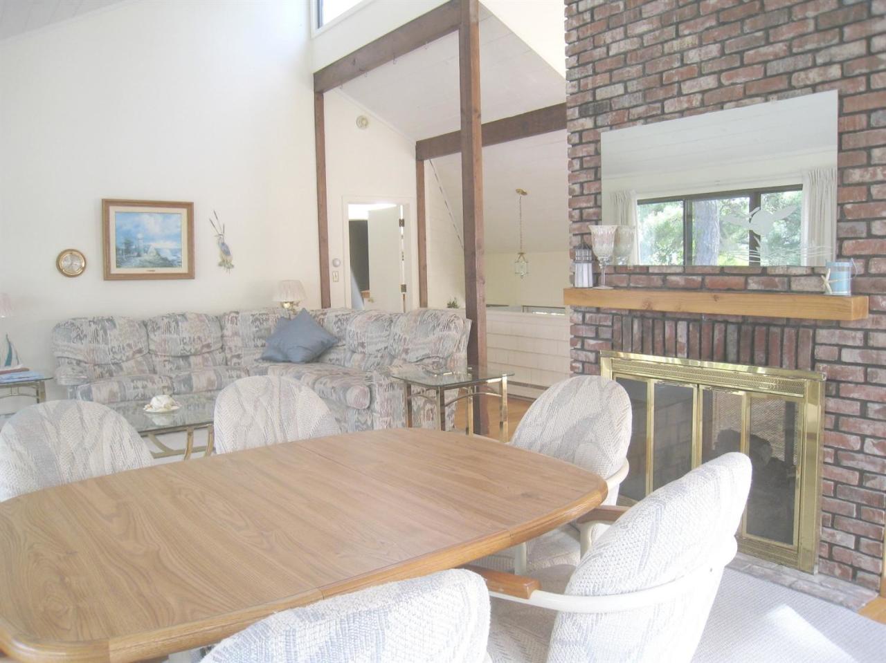 72 Clam Shell Point Lane Cotuit, MA 02635 - Photo 12 of 35 a living room with furniture and a fireplace