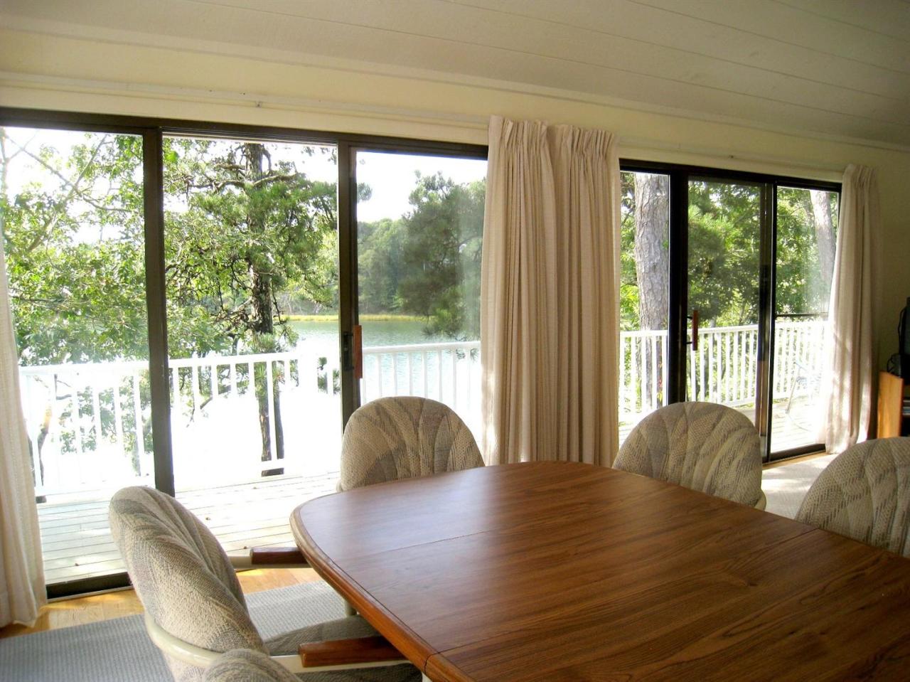 72 Clam Shell Point Lane Cotuit, MA 02635 - Photo 13 of 35 a view of a dining room with furniture and wooden floor