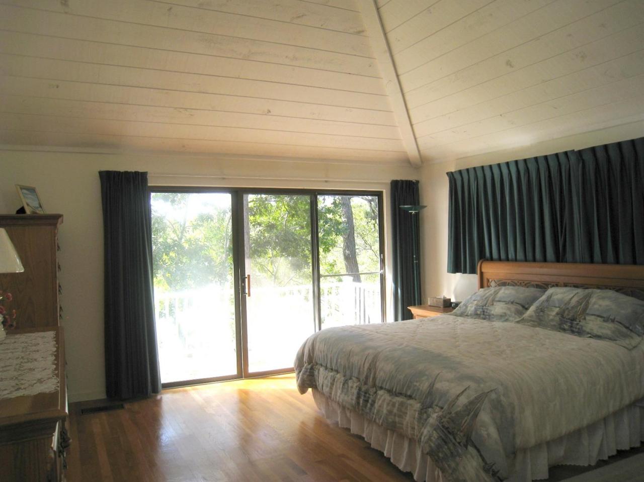 72 Clam Shell Point Lane Cotuit, MA 02635 - Photo 14 of 35 a bedroom with a bed and a large window