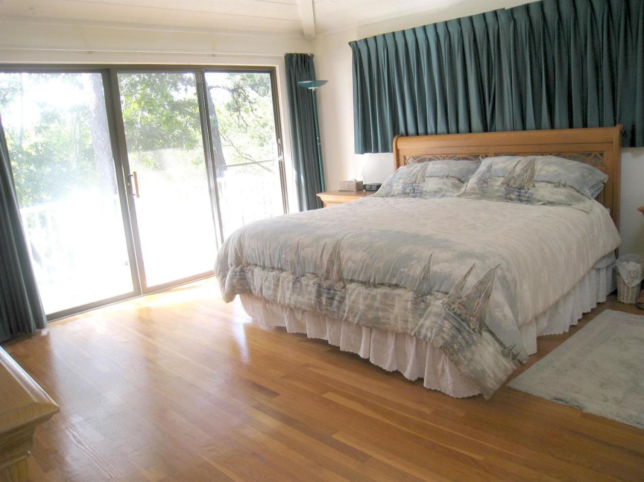 72 Clam Shell Point Lane Cotuit, MA 02635 - Photo 15 of 35 a bedroom with a bed and a large window