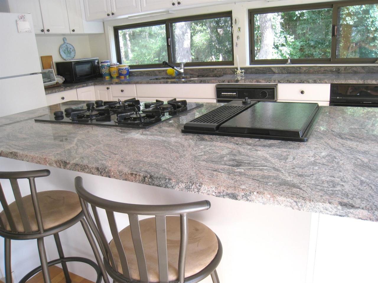 72 Clam Shell Point Lane Cotuit, MA 02635 - Photo 7 of 35 a kitchen with stainless steel appliances granite countertop a stove a sink and a granite counter tops
