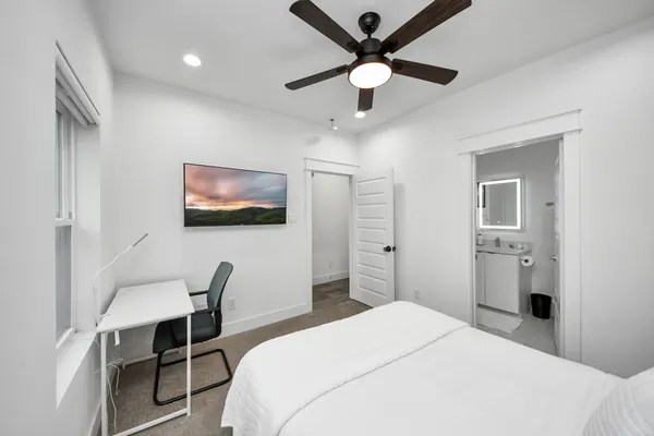 a bedroom with a bed and a chandelier