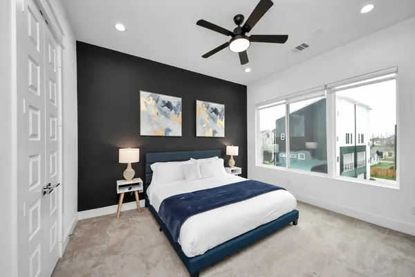 a bedroom with a large bed and a large window